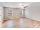 Bright, airy bedroom features wood-look floors, ceiling fan, and double windows at 2679 Southern Trace Dr, Waxhaw, NC 28173