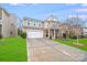 Beautiful home showcasing a manicured front lawn, two-car garage, and a welcoming entrance at 2679 Southern Trace Dr, Waxhaw, NC 28173