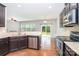 A modern kitchen featuring granite countertops, stainless steel appliances, and sleek, dark-stained cabinetry at 2679 Southern Trace Dr, Waxhaw, NC 28173