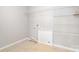 The laundry room features tiled floor and wire racks for storage and organization at 2679 Southern Trace Dr, Waxhaw, NC 28173
