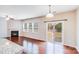 Bright living area with hardwood floors, a fireplace, and a sliding glass door leading to the backyard at 2679 Southern Trace Dr, Waxhaw, NC 28173