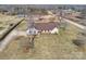 Aerial view of home with brown roof, stone foundation, outbuildings, and a spacious yard at 332 Goforth Rd, Kings Mountain, NC 28086