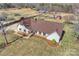 Aerial view of home featuring stone foundation, brown roof, outbuildings, and a large manicured lawn at 332 Goforth Rd, Kings Mountain, NC 28086