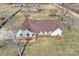 Aerial view of a home with brown roof, stone foundation, outbuildings, and a spacious yard at 332 Goforth Rd, Kings Mountain, NC 28086