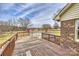 Backyard showcasing a wooden deck, above-ground pool, red barn with a spacious grassy area at 332 Goforth Rd, Kings Mountain, NC 28086