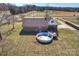 Aerial view of backyard featuring a deck, an above ground pool, and brick home at 332 Goforth Rd, Kings Mountain, NC 28086