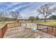 Backyard showcasing a wooden deck, above-ground pool, red barn with a spacious grassy area at 332 Goforth Rd, Kings Mountain, NC 28086