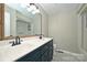 Updated bathroom features a double vanity, framed mirror, and a tub with a shower at 332 Goforth Rd, Kings Mountain, NC 28086