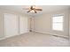Neutral bedroom with plush carpet, fan, closet and natural light from the window at 332 Goforth Rd, Kings Mountain, NC 28086