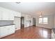 Spacious open kitchen features white cabinets, black countertop and appliances, and hardwood floors at 332 Goforth Rd, Kings Mountain, NC 28086