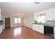 Eat-in kitchen features white cabinets, black appliances, and hardwood flooring, providing a classic aesthetic at 332 Goforth Rd, Kings Mountain, NC 28086