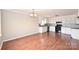 Kitchen and dining area with hardwood floors, white cabinets, tile backsplash, and black appliances at 332 Goforth Rd, Kings Mountain, NC 28086