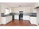 Bright kitchen features white cabinets, dark counter tops, and stainless steel sink, all over hardwood floors at 332 Goforth Rd, Kings Mountain, NC 28086