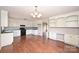 Bright kitchen has plenty of storage with white cabinets, black appliances, and hardwood flooring at 332 Goforth Rd, Kings Mountain, NC 28086