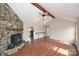 Cozy living room featuring wood floors, exposed wood beam, and a stone fireplace at 332 Goforth Rd, Kings Mountain, NC 28086