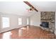 Inviting living room boasts a stone fireplace, wood beam, vaulted ceiling, and an abundance of natural light at 332 Goforth Rd, Kings Mountain, NC 28086