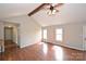 Bright living room with wood floors, vaulted ceiling, exposed beam and multiple windows for ample natural light at 332 Goforth Rd, Kings Mountain, NC 28086