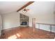 Inviting living room with vaulted ceiling, ceiling fan, wood floors, and a stone fireplace at 332 Goforth Rd, Kings Mountain, NC 28086