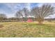 Charming red outbuilding nestled in a spacious yard, adding character to the property at 332 Goforth Rd, Kings Mountain, NC 28086