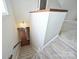 Carpeted stairs leading to a lower level with a glimpse of hardwood flooring and a doorway at 332 Goforth Rd, Kings Mountain, NC 28086
