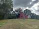Quaint red barn atop a grassy hill, offering storage solutions and country charm at 33320-B Hobe Rd, Albemarle, NC 28001