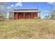 Charming red barn on a picturesque grassy hill, offering rustic appeal and versatile storage options at 33320-B Hobe Rd, Albemarle, NC 28001