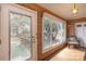 Brick-walled entryway with diamond-paned windows and a door at 33320-B Hobe Rd, Albemarle, NC 28001