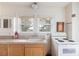 Charming kitchen featuring a stainless steel sink and an electric stove underneath a pair of windows at 33320-B Hobe Rd, Albemarle, NC 28001