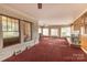 Spacious living room with large windows, carpet, and a fireplace at 33320-B Hobe Rd, Albemarle, NC 28001