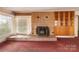 Living room features a brick fireplace, built-in cabinets, and a large window at 33320-B Hobe Rd, Albemarle, NC 28001