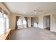 Sunlit living room with large windows, neutral carpet, ceiling fan and an open doorway at 33320-B Hobe Rd, Albemarle, NC 28001