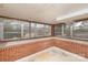 Enclosed sunroom with brick base, surrounded by windows, offering plenty of natural light and outdoor views at 33320-B Hobe Rd, Albemarle, NC 28001
