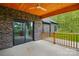 Covered back porch made of brick with wood ceiling, ceiling fan and wood railing overlooking backyard at 3738 Glen Arbor Dr, Maiden, NC 28650