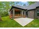 Brick home's backyard featuring covered patio and stone patio at 3738 Glen Arbor Dr, Maiden, NC 28650