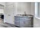 A contemporary bar area features gray cabinets, a marble countertop, and modern fixtures, perfect for entertaining guests at 3738 Glen Arbor Dr, Maiden, NC 28650