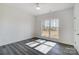 A serene bedroom offers ample natural light through a large window, complemented by sleek, modern flooring at 3738 Glen Arbor Dr, Maiden, NC 28650