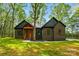 Stunning brick home featuring a welcoming wood porch in a lush, wooded setting with healthy, green lawn at 3738 Glen Arbor Dr, Maiden, NC 28650