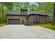 This house features a two-car garage and neutral paint scheme that blends in with the landscape at 3738 Glen Arbor Dr, Maiden, NC 28650
