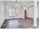 Bright open-concept foyer featuring hardwood floors, a stylish pendant light, and a wooden front door at 3738 Glen Arbor Dr, Maiden, NC 28650