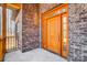 Elegant front door with side lights, set in a textured brick facade, showcasing craftsman design at 3738 Glen Arbor Dr, Maiden, NC 28650