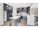 Modern kitchen with dark cabinetry, quartz countertops, and an island with a breakfast bar at 3738 Glen Arbor Dr, Maiden, NC 28650