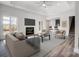 Open-concept living room with fireplace, modern furnishings, and access to a bar area at 3738 Glen Arbor Dr, Maiden, NC 28650