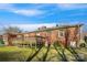 A view of the backyard, complete with a deck, brick exterior, and a well-maintained lawn area at 3901 Starmount Ave, Charlotte, NC 28269