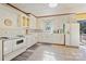 Bright kitchen with white cabinets, tile backsplash, and white appliances at 3901 Starmount Ave, Charlotte, NC 28269