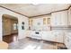 Bright kitchen with white appliances and cabinetry, connecting to a sunny living area at 3901 Starmount Ave, Charlotte, NC 28269