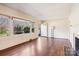 Bright living room featuring hardwood floors, a large window, and a classic fireplace at 3901 Starmount Ave, Charlotte, NC 28269