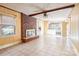 Open-concept living space with fireplace and tile floors connecting to the kitchen at 3901 Starmount Ave, Charlotte, NC 28269