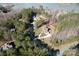 Aerial view showcasing a stately home nestled among trees in a lakeside community at 4616 Gold Finch Dr, Denver, NC 28037