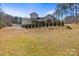 Expansive backyard of a multi-story home with a pristine lawn and mature trees at 4616 Gold Finch Dr, Denver, NC 28037