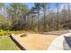 Backyard patio featuring a fire pit, bench, and view of the surrounding trees at 4616 Gold Finch Dr, Denver, NC 28037